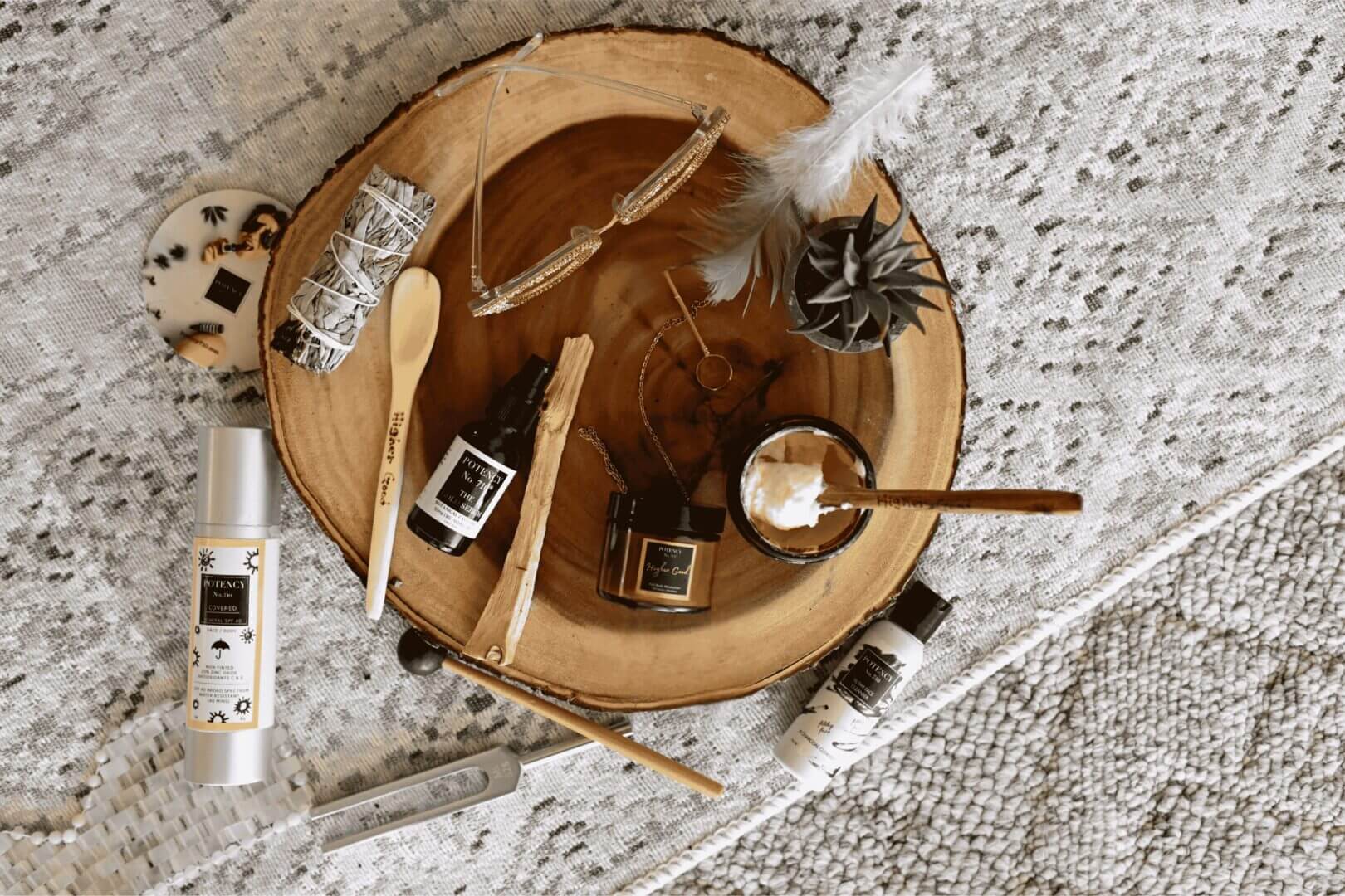 Assorted Potency No. 710 lifestyle products on a wooden tray, showcasing natural wellness items, only available at Potency No. 710.